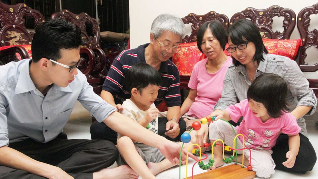 Multi-generation family having a calm planning conversation at home in Singapore (illustrative)
